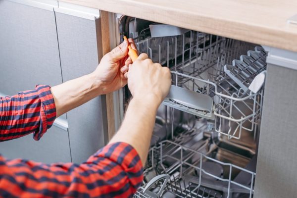 man-repairing-dishwasher-male-hand-with-screwdriv-2023-11-27-05-09-59-utc-1-1024x683